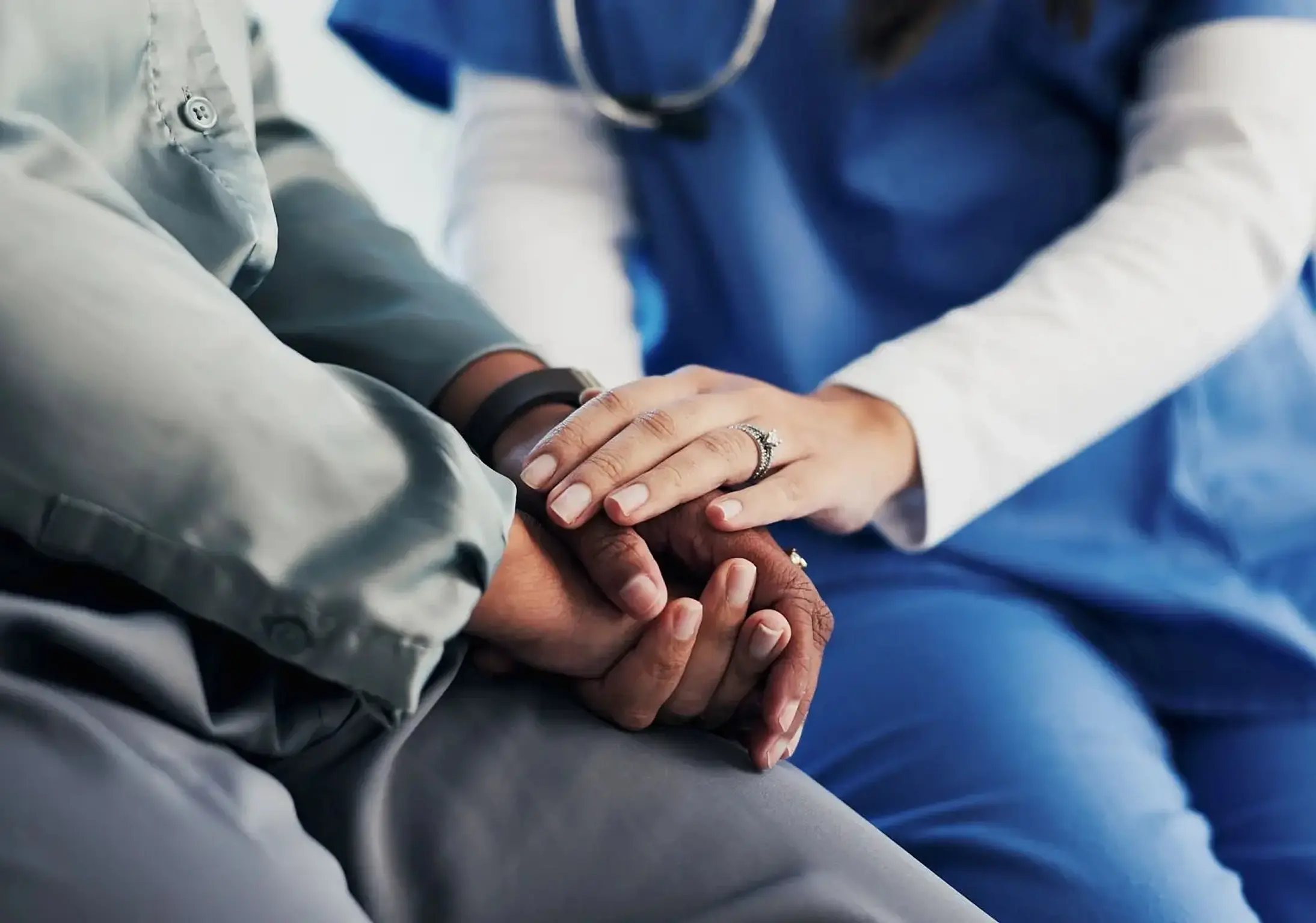 Doctor comforting patient with gentle touch.